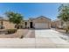 Charming single-story home featuring a two-car garage and low maintenance desert landscaping at 3112 N 303Rd Dr, Buckeye, AZ 85396