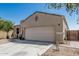 Single-story home featuring a two-car garage and desert landscaping at 3112 N 303Rd Dr, Buckeye, AZ 85396