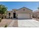 Single-story home featuring a two-car garage and low maintenance desert landscaping at 3112 N 303Rd Dr, Buckeye, AZ 85396