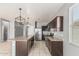 A spacious kitchen features granite countertops, stainless steel appliances, and modern pendant lighting at 3112 N 303Rd Dr, Buckeye, AZ 85396