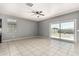 Open living space featuring tile floors and a sliding glass door to the backyard at 3112 N 303Rd Dr, Buckeye, AZ 85396