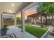 Backyard oasis featuring a covered patio, pergola, artificial turf, and an outdoor seating area at 31332 N 137Th Ln, Peoria, AZ 85383