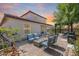 Spacious backyard with a fire pit, blue outdoor seating, BBQ, pergola, and manicured landscaping at 31332 N 137Th Ln, Peoria, AZ 85383