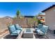 Outdoor patio with seating, a fire pit, and a charming rock garden feature at 31332 N 137Th Ln, Peoria, AZ 85383