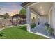 Beautiful backyard with a covered patio, pergola, artificial grass, and an outdoor seating area at 31332 N 137Th Ln, Peoria, AZ 85383