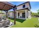 Spacious backyard features a covered patio, artificial grass, and a pergola swing at 31332 N 137Th Ln, Peoria, AZ 85383