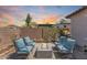 Inviting backyard with comfortable seating around a modern fire pit and desert-inspired landscaping at 31332 N 137Th Ln, Peoria, AZ 85383