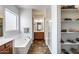 Bathroom with soaking tub, shower, double sink vanity, and walk-in closet at 31332 N 137Th Ln, Peoria, AZ 85383