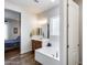 Bathroom features a soaking tub, double sinks, vanity, and a view into the primary bedroom at 31332 N 137Th Ln, Peoria, AZ 85383