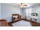 Cozy bedroom featuring a baby crib, vanity table, ceiling fan, and a window for natural light at 31332 N 137Th Ln, Peoria, AZ 85383