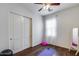Cozy bedroom with wood floors, ceiling fan, closet, and bright natural light at 31332 N 137Th Ln, Peoria, AZ 85383