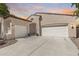 Attractive home exterior showcasing a three-car garage and lovely landscaping at 31332 N 137Th Ln, Peoria, AZ 85383