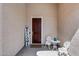 A cozy front entrance featuring a wooden door, seating area, and a decorative 'welcome' sign at 31332 N 137Th Ln, Peoria, AZ 85383