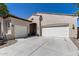 A beautiful single-story home featuring a three-car garage, desert landscaping, and a welcoming front entrance at 31332 N 137Th Ln, Peoria, AZ 85383