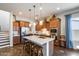 Stylish kitchen featuring a center island, stainless appliances, and wood cabinetry at 31332 N 137Th Ln, Peoria, AZ 85383