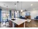Spacious kitchen island with bar seating and seamless transition to the living room at 31332 N 137Th Ln, Peoria, AZ 85383