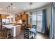 Bright kitchen boasts stainless steel appliances, center island, and adjacent dining area at 31332 N 137Th Ln, Peoria, AZ 85383