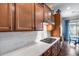 Modern kitchen with stainless steel appliances, white backsplash, and wood cabinetry at 31332 N 137Th Ln, Peoria, AZ 85383