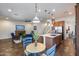 Open-concept living area with fireplace, stairs, kitchen, and dining area at 31332 N 137Th Ln, Peoria, AZ 85383
