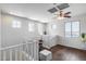 Upstairs loft area with hardwood floors, four windows allowing natural light in, and a ceiling fan at 31332 N 137Th Ln, Peoria, AZ 85383