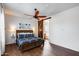 Main bedroom featuring a sliding barn door to the ensuite bathroom and a ceiling fan at 31332 N 137Th Ln, Peoria, AZ 85383