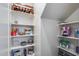 Organized walk-in pantry with shelving for storage of food items and supplies at 31332 N 137Th Ln, Peoria, AZ 85383