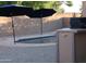 Close up of the backyard pool with umbrellas providing shade and a built in barbecue at 3247 E Lark Ct, Gilbert, AZ 85297