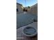 View of the rock backyard with a fire pit with a rock in the middle at 3247 E Lark Ct, Gilbert, AZ 85297