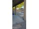 Covered back patio with desert rock backyard landscaping leading to an inground swimming pool at 3247 E Lark Ct, Gilbert, AZ 85297