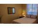 Bedroom featuring a mirror, a large window, comfortable bed, and bedside table with a lamp at 3247 E Lark Ct, Gilbert, AZ 85297