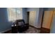 Comfortable bedroom with a plush recliner, window with blinds, and closet space at 3247 E Lark Ct, Gilbert, AZ 85297
