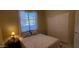 Bedroom featuring a large window, closet, comfortable bed, and bedside table with a lamp at 3247 E Lark Ct, Gilbert, AZ 85297