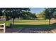 Community grassy area with a decorative dry creek bed and mature trees at 3247 E Lark Ct, Gilbert, AZ 85297