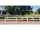 White fence borders a wide swath of well-maintained grass and mature trees at 3247 E Lark Ct, Gilbert, AZ 85297