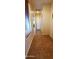 Hallway featuring light neutral walls, a dark-colored tile floor, and a white door to another room at 3247 E Lark Ct, Gilbert, AZ 85297