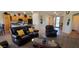 Bright living room featuring neutral walls, tile flooring, and brown leather seating at 3247 E Lark Ct, Gilbert, AZ 85297