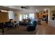 Spacious living room featuring neutral walls, brown leather seating, and an open layout to the kitchen at 3247 E Lark Ct, Gilbert, AZ 85297