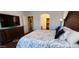 Main bedroom with wood flooring, neutral walls, and view to the en-suite bathroom and closet at 3247 E Lark Ct, Gilbert, AZ 85297