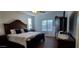 Bright main bedroom boasts a large window, beautiful furnishings and wood flooring at 3247 E Lark Ct, Gilbert, AZ 85297