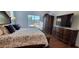 Bright main bedroom boasts a large window, beautiful furnishings and wood flooring at 3247 E Lark Ct, Gilbert, AZ 85297