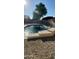 Gorgeous pool with desert rock landscaping and patio umbrellas offering a refreshing outdoor space to unwind at 3247 E Lark Ct, Gilbert, AZ 85297