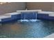 Beautiful pool with a unique waterfall feature and tiled border, providing a relaxing outdoor oasis at 3247 E Lark Ct, Gilbert, AZ 85297