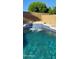 Inviting pool featuring a waterfall, tiled border, and clear blue water perfect for outdoor relaxation at 3247 E Lark Ct, Gilbert, AZ 85297