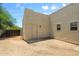 Backyard featuring stucco walls, gravel groundcover, and access door to the home at 32826 N 54Th St, Cave Creek, AZ 85331