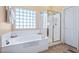Bright bathroom with a soaking tub and glass enclosed shower at 32826 N 54Th St, Cave Creek, AZ 85331