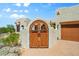 Close-up of the entrance featuring a double-door with a decorative archway at 32826 N 54Th St, Cave Creek, AZ 85331