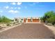 Stunning desert home featuring a gravel driveway, two-car garage and mature landscaping at 32826 N 54Th St, Cave Creek, AZ 85331