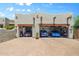 Three-car garage featuring a paver driveway and a variety of vehicles parked inside the open bays at 32826 N 54Th St, Cave Creek, AZ 85331