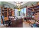 Cozy home office featuring built-in bookshelves, a comfortable chair, and a well-lit workspace at 32826 N 54Th St, Cave Creek, AZ 85331