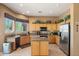 Functional kitchen with light wood cabinets, granite countertops, and stainless appliances at 32826 N 54Th St, Cave Creek, AZ 85331